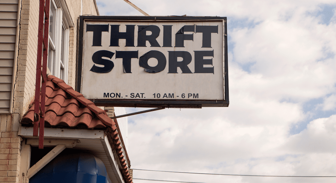 Thrift store outdoor sign with opening days and timings