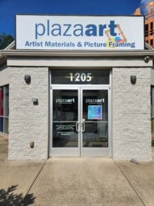Front view of the plazaart store, displaying its double doors under a sign that reads "artist materials & picture framing," located at address 1205.