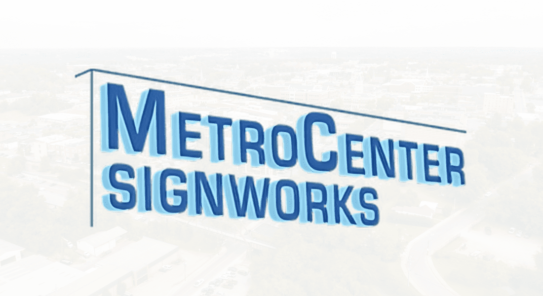 Logo of MetroCenter SignWorks with the company name in bold blue uppercase letters, positioned in front of a faint image of an urban landscape. Signage Company Near You.