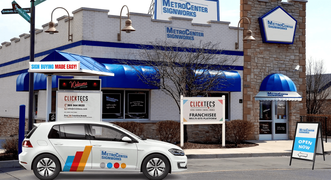 A storefront for MetroCenter Signworks with signage and a company-branded car parked in front, promoting ClickTecs franchisee opportunities. Your Trusted Sign Company in South Nashville, TN