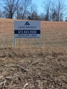 A sign in a field reads &ldquo;Land Advisors Organization, 615.845.9500, For Sale | Eric S. Deems, Approved 14-Build Townhome Site.&rdquo;.
