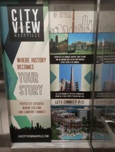 Promotional display for City View Nashville, highlighting history, amenities, and modern living, with images of buildings and the slogan "Where history becomes your story.